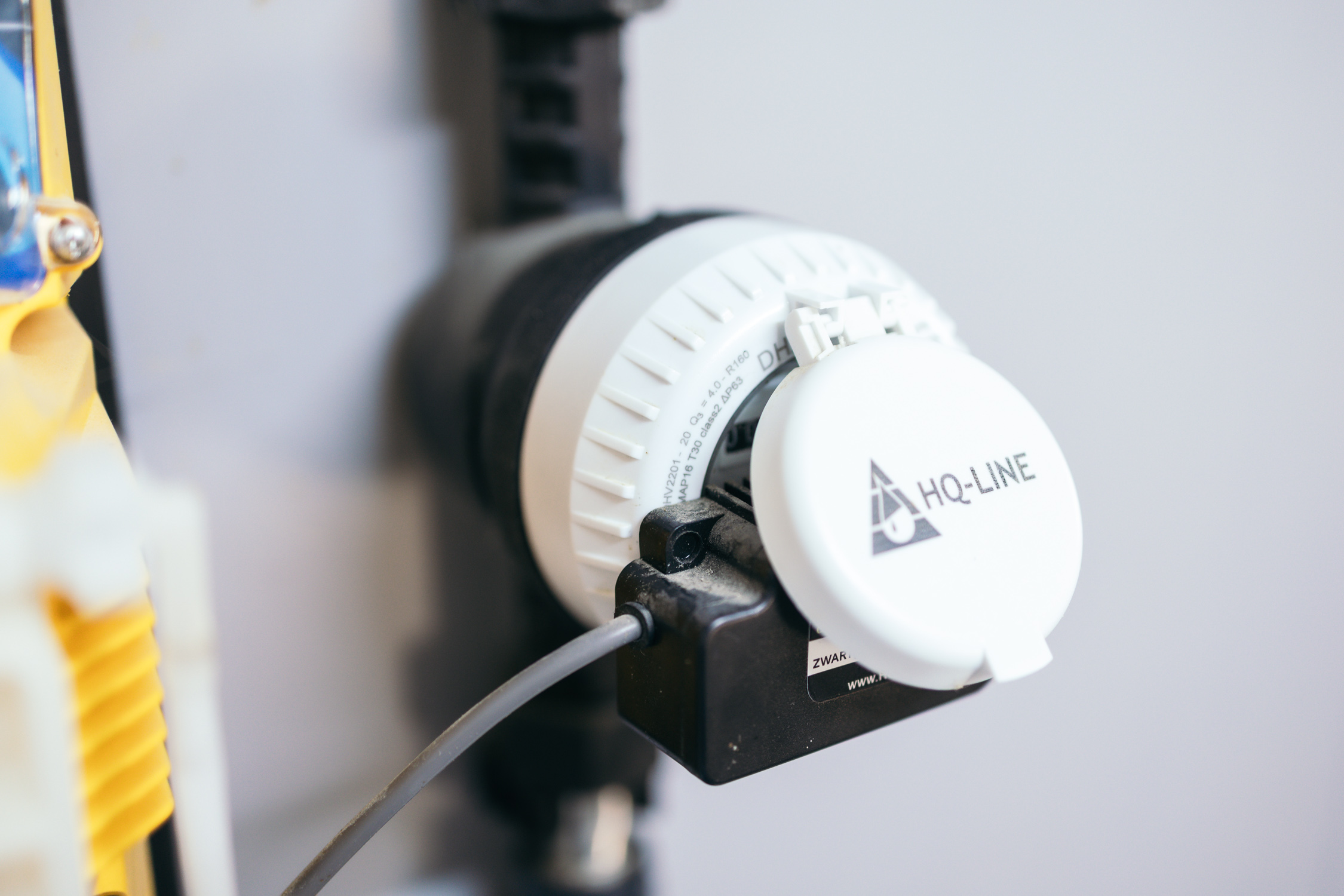 Man Using Measuring Tape in Factory Setting Man Using Measuring Tape in Factory Setting